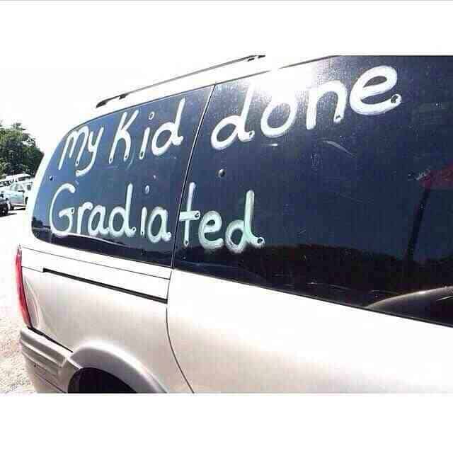 Car window paint celebrating a child who "Done Gradiated" with a major spelling error.