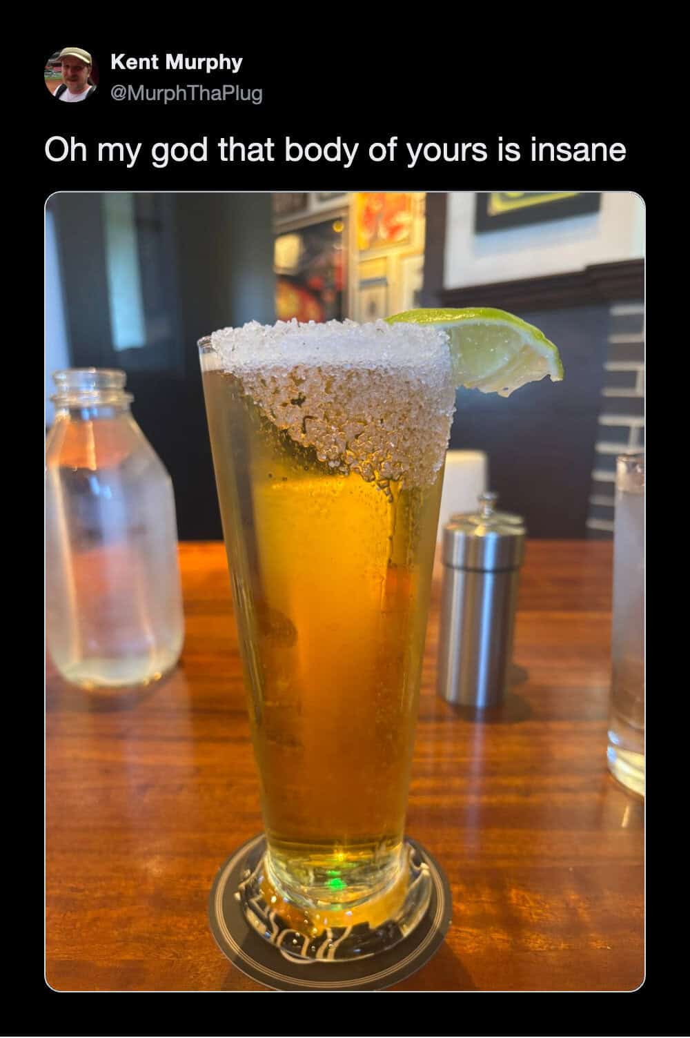 A funny tweet parodying leaked celebrity messages by showing a beautifully poured, perfectly chilled tall glass of beer with a salted rim and lime wedge, affectionately captioned "oh my god that body of yours is insane," earning a spot among the funniest tweets.