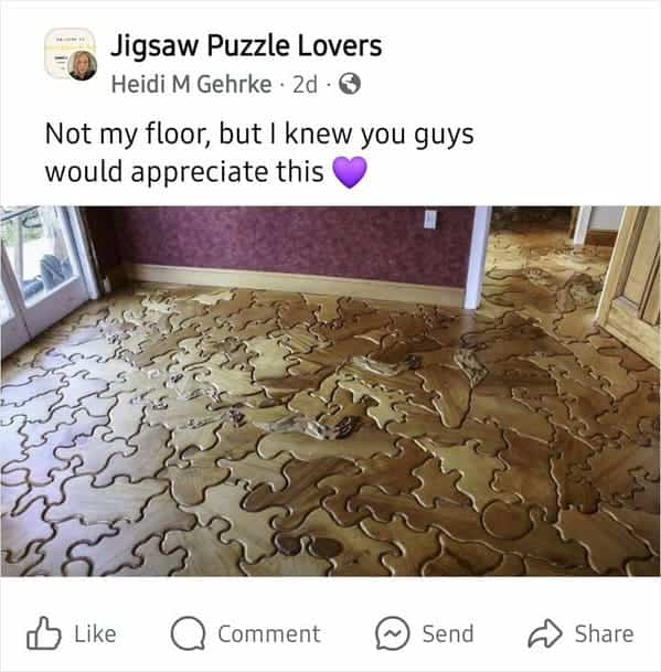 A wooden floor made of interlocking puzzle pieces with deep grooves between every individual segment.