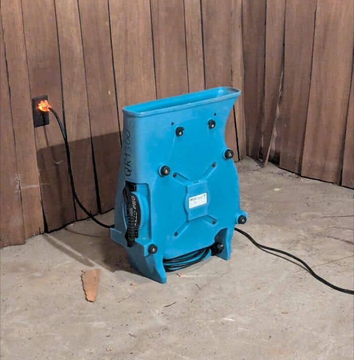 industrial find of inanimate objects with faces featuring a blue floor blower fan, where its black rubber feet and molded plastic back look exactly like a surprised, screaming face.