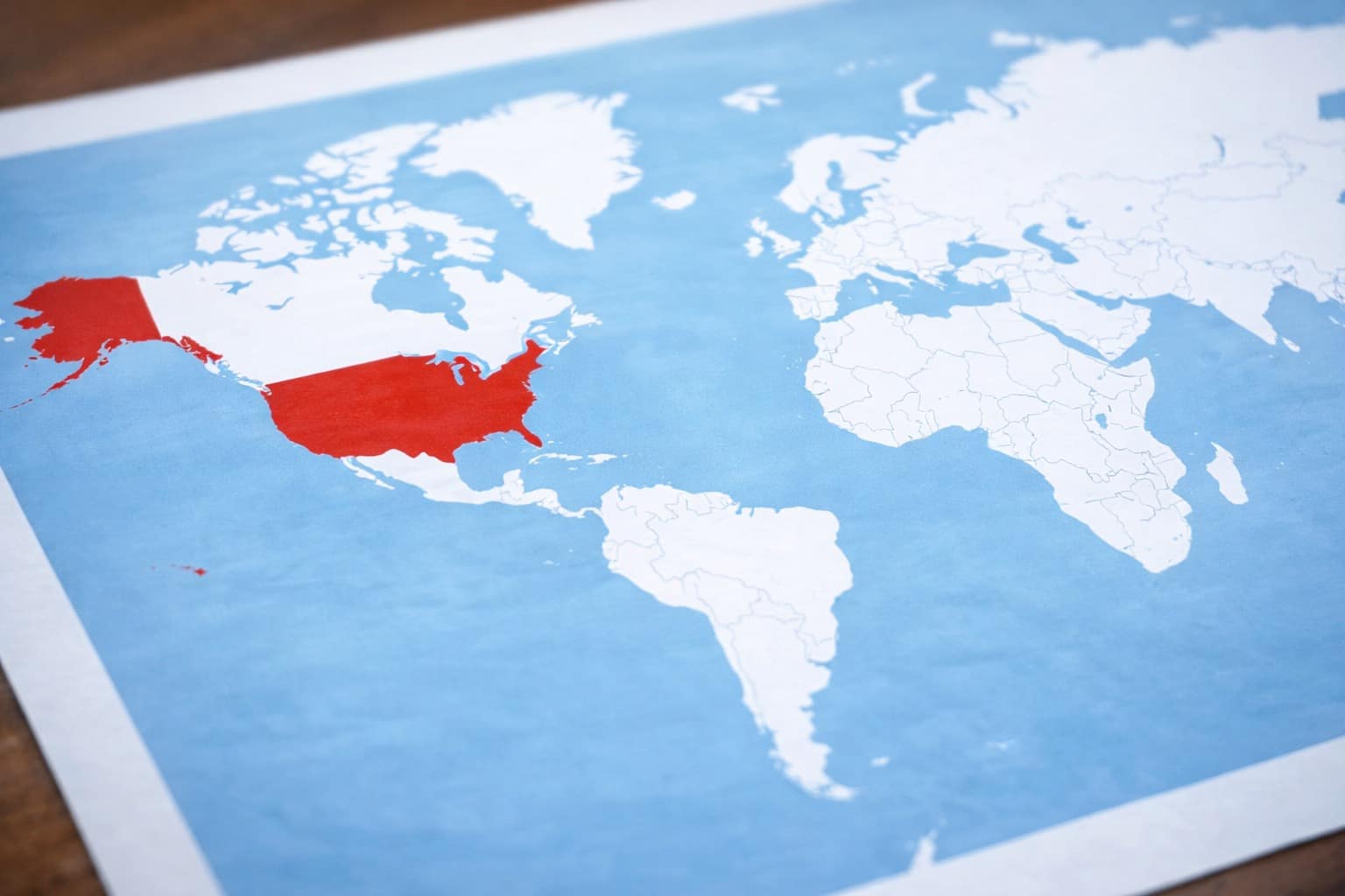 A collage of interesting maps featuring the vein-like blue network of the Mississippi River drainage basin, the multi-map correlation between prehistoric soil and modern Alabama election results, and the dramatic high-definition transformation of Pluto from 1994 to 2019.