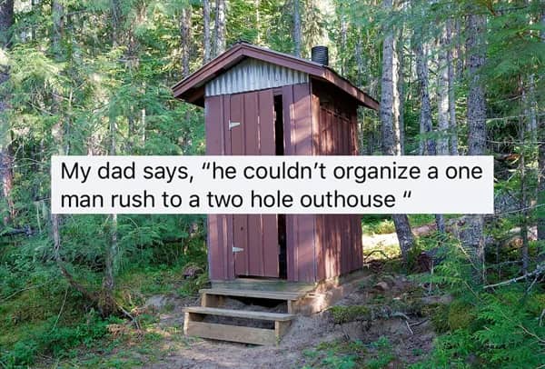 Wooden two-hole outhouse in a forest with a text overlay about a one-man organizing failure.