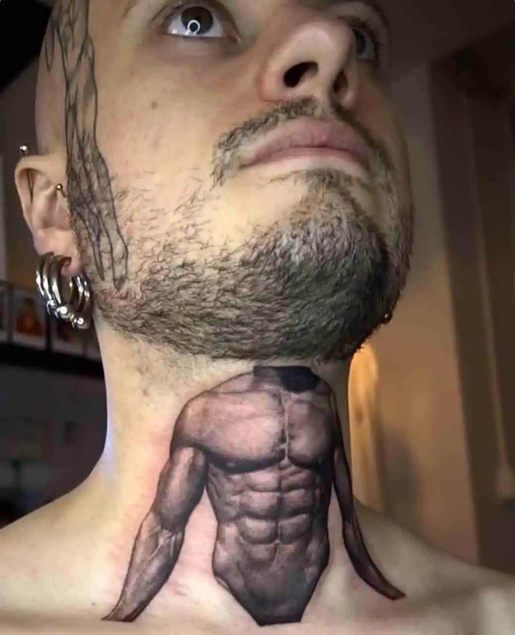 cursed entry in this meme dump featuring a man with a bizarre neck tattoo that depicts a hyper-realistic, muscular male torso, effectively giving his head a tiny, secondary set of abs and pecs.