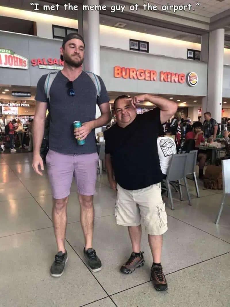 A hilarious meme featuring a photo of a tall man standing next to "Big Ed" from 90 Day Fiancé at an airport Burger King. The caption reads, "I met the meme guy at the airport."
