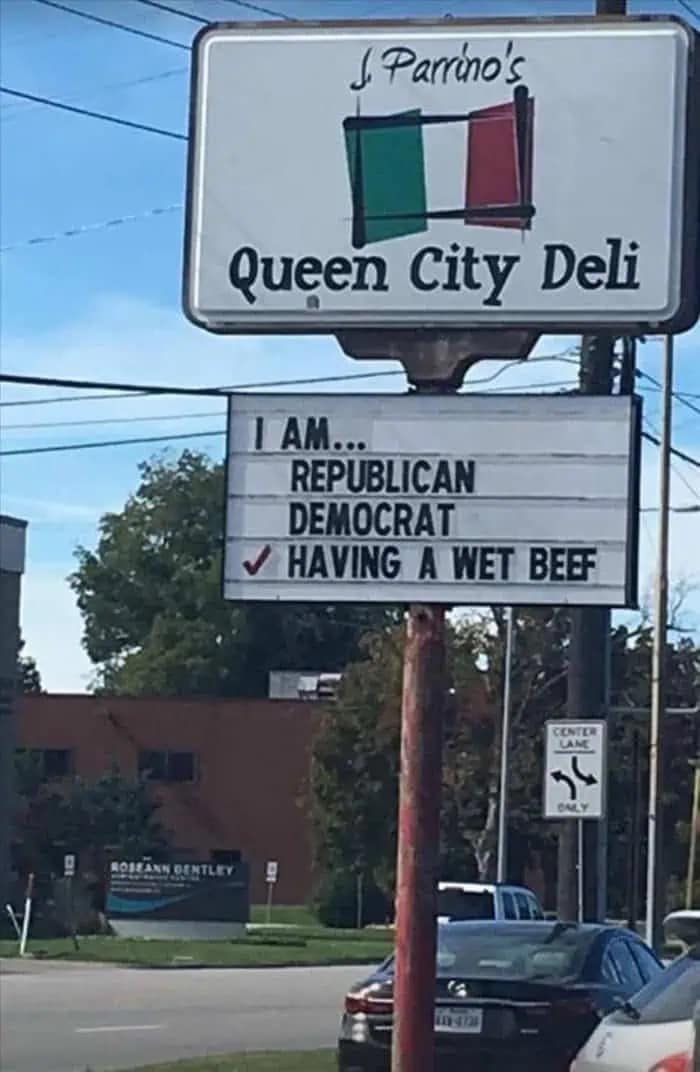 A hilarious real-world photo of a deli marquee that lists political affiliations like Republican and Democrat, but has a checkmark next to the third option: "HAVING A WET BEEF."