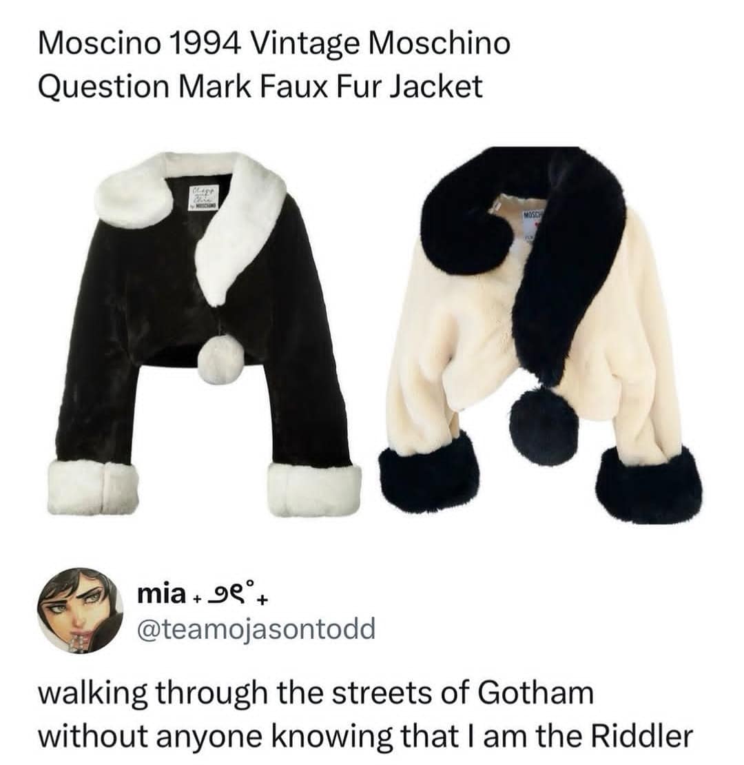 wildly specific fashion funny meme featuring a vintage Moschino faux fur jacket shaped exactly like a giant question mark, paired with a caption joking about walking through Gotham without anyone knowing you are the Riddler.