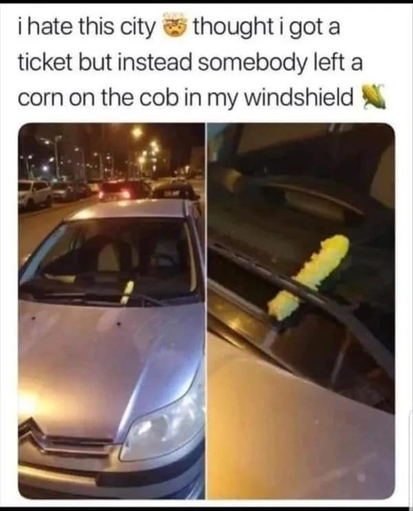 Car parked at night with a literal corn on the cob tucked under the windshield wiper instead of a parking ticket. Chaotic city energy in this meme dump