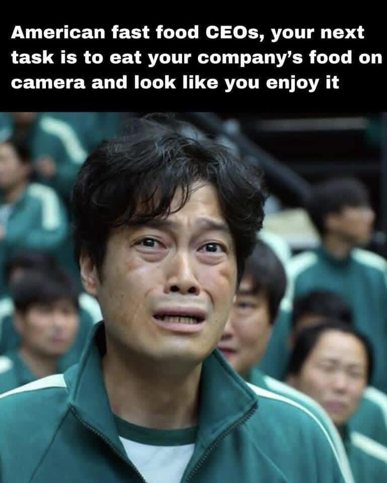 A top-tier funny meme showing the crying protagonist from Squid Game reacting to the absolute torture of American fast food CEOs having to eat their own terrible food and pretend to actually like it in this meme dump.