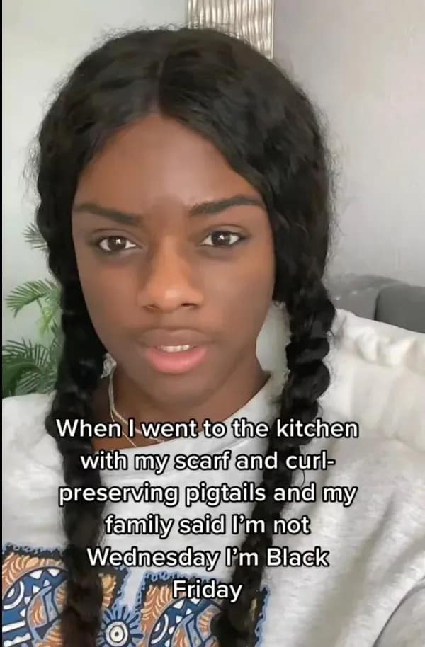 funny meme featuring a Black woman with her hair in curl-preserving pigtails and a headscarf; the text jokes that when she went to the kitchen, her family told her she wasn’t "Wednesday" Addams, she was "Black Friday."