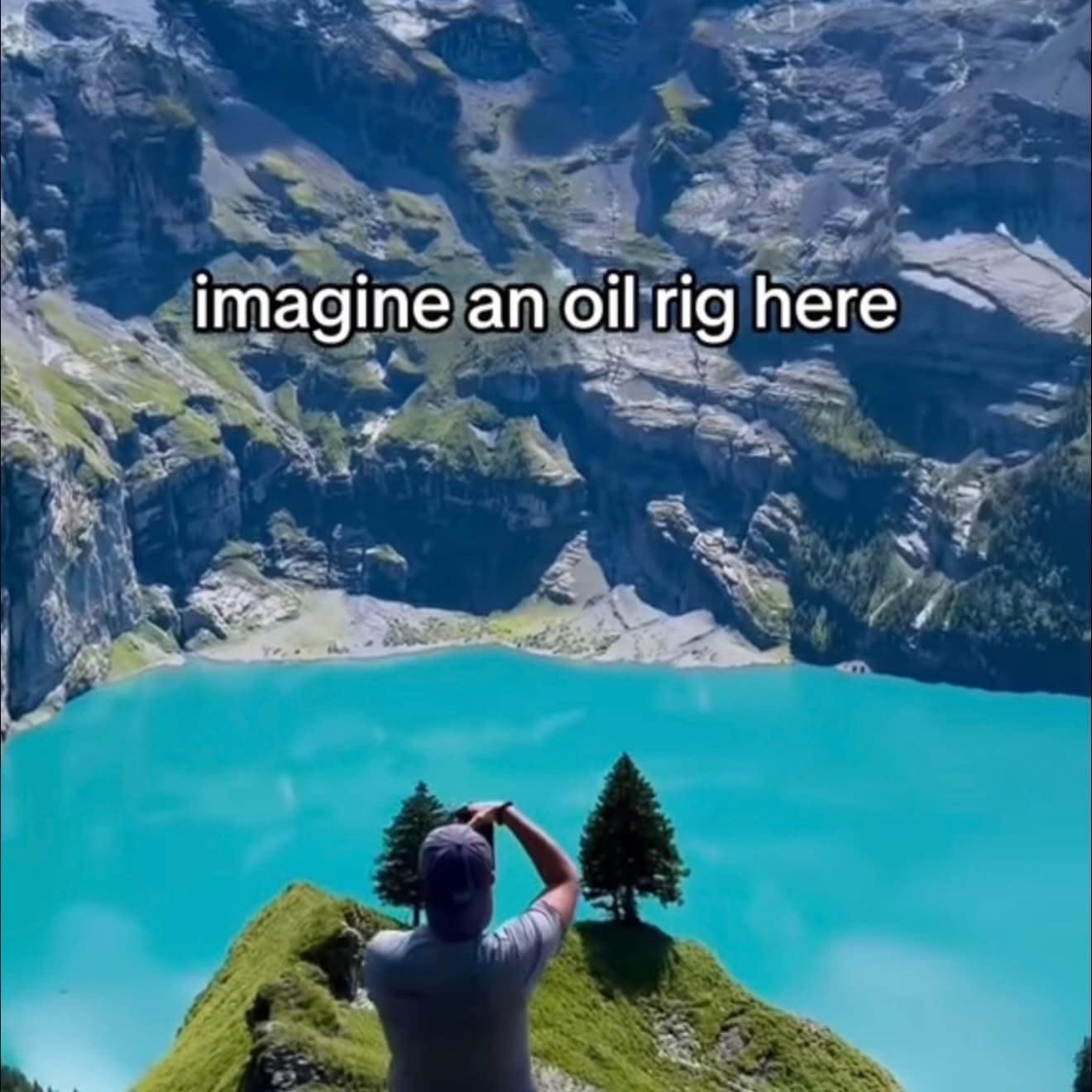 A breathtaking landscape photo of a pristine alpine lake and jagged mountains with a cynical, anti-industrial text overlay suggesting the viewer "imagine an oil rig here."