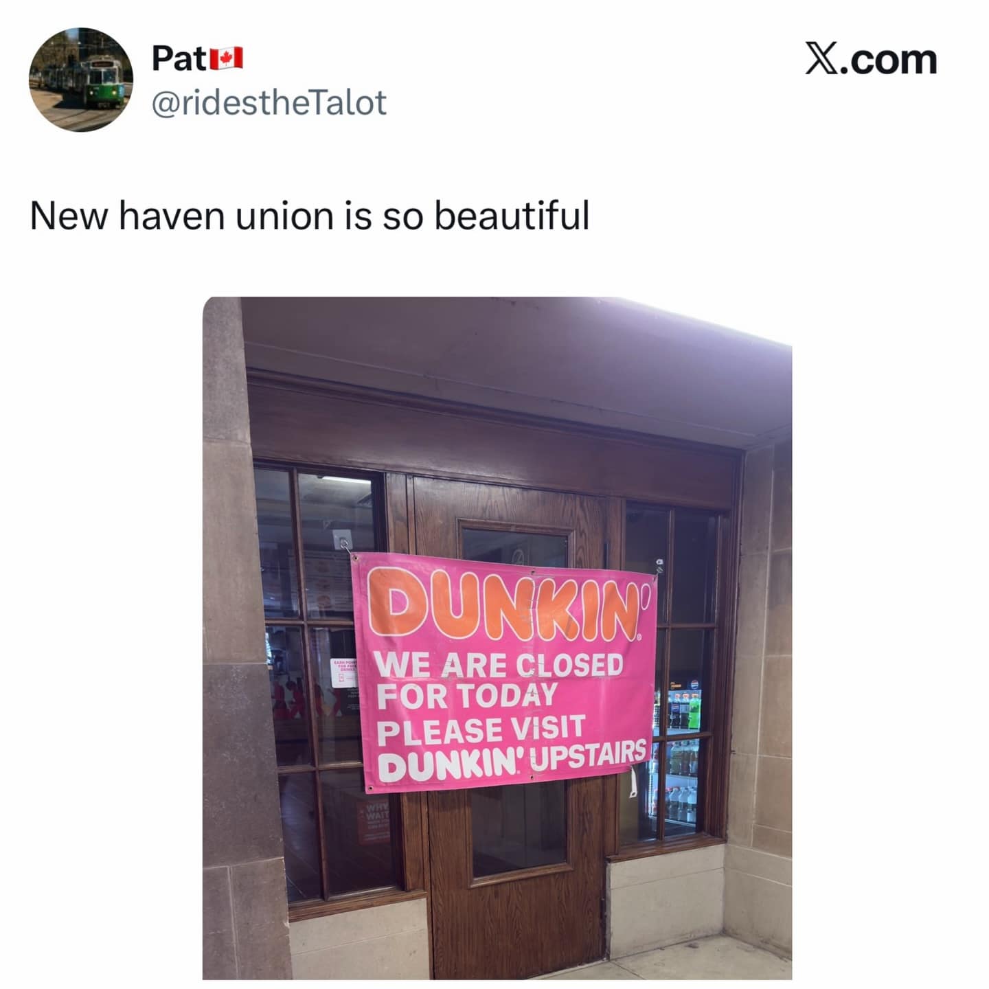 satirical X post highlighting the "beauty" of New Haven Union station. The photo shows a Dunkin' storefront that is closed, featuring a large pink banner that simply redirects frustrated travelers to the "Dunkin' Upstairs."