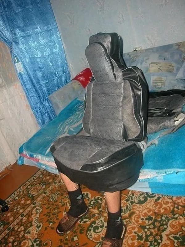 An absolutely unhinged visual of a guy sitting on a bed wearing a literal black and grey car seat cover as a full body outfit. Pure chaotic energy in this hilarious meme dump.