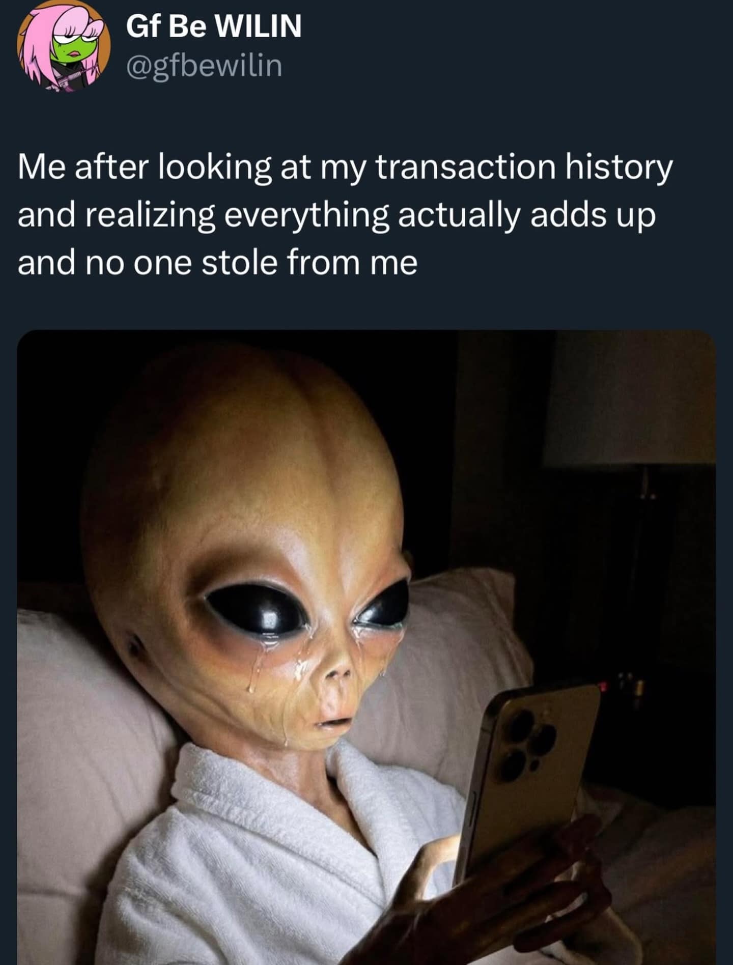 A grey alien sits in bed, tears streaming down its face while staring at a smartphone, perfectly capturing the hilarious meme energy of realizing your bank account is empty because of your own spending, not fraud.