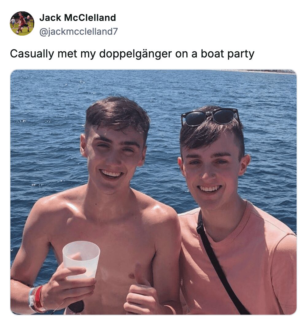 Two young men with similar haircuts and facial features smiling on a sunny boat party.