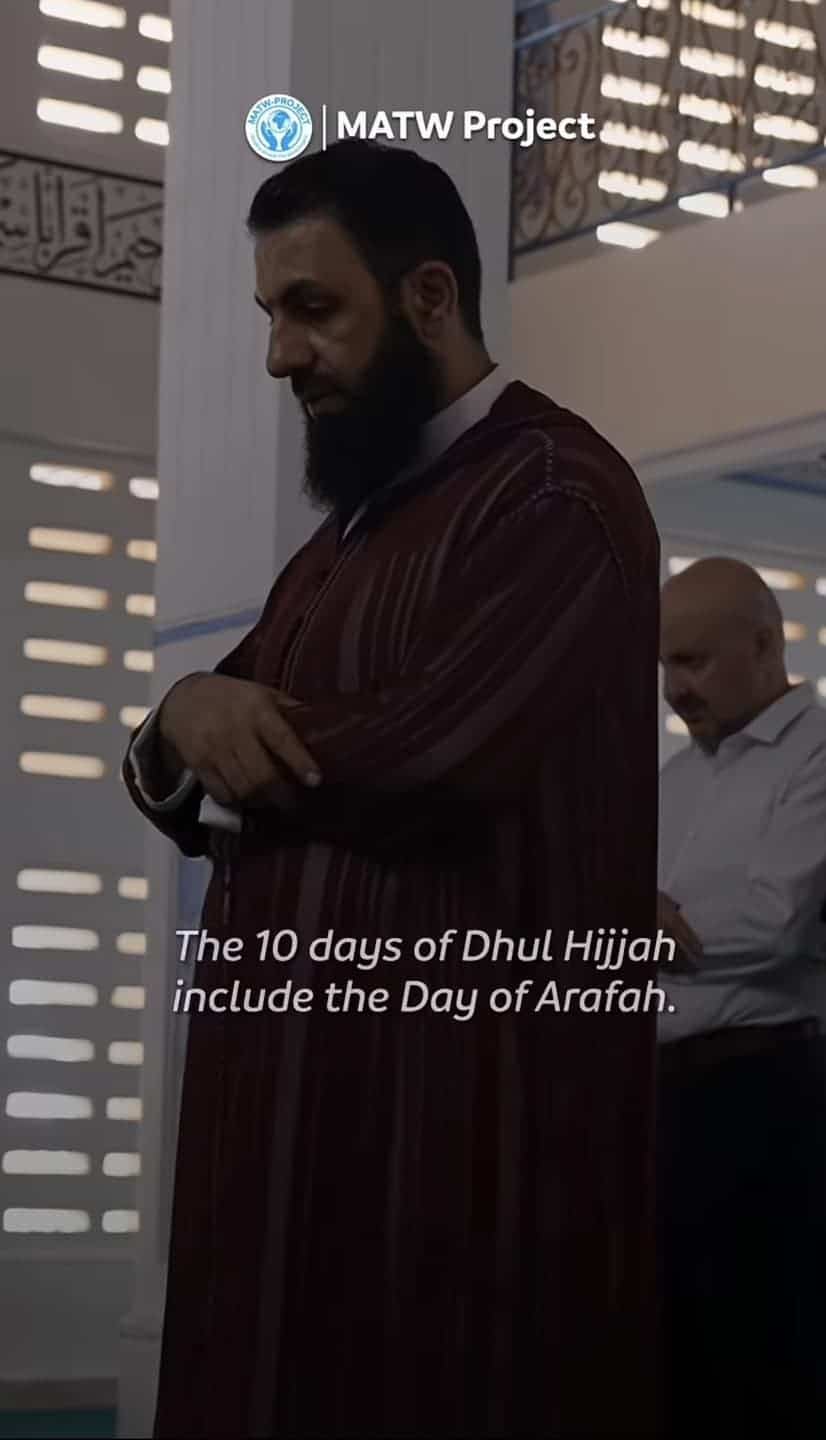 A bearded man in traditional religious clothing who shares the facial structure of the comedian.