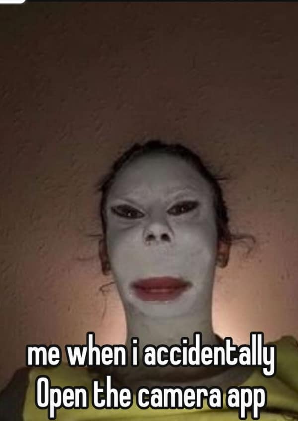 A terrifyingly relatable meme showing a close-up of a person with white face cream and a distorted filter that makes their eyes tiny and forehead massive. The caption reads: "me when i accidentally Open the camera app."