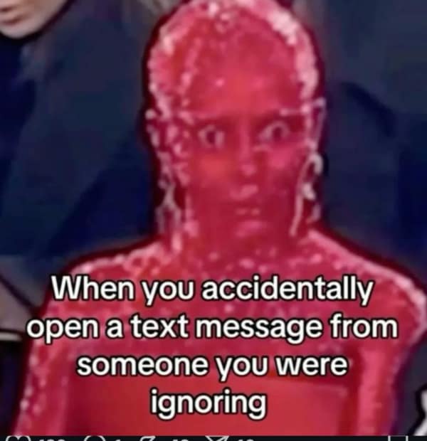 A high-anxiety relatable meme showing a blurry, low-resolution, and deep-fried red image of Doja Cat in her viral red crystal outfit, looking wide-eyed and frozen in shock. The caption reads: "When you accidentally open a text message from someone you were ignoring."