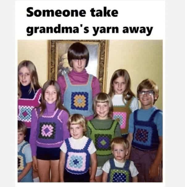 Humorous vintage family photo showing eight children wearing matching handmade granny square crochet vests.