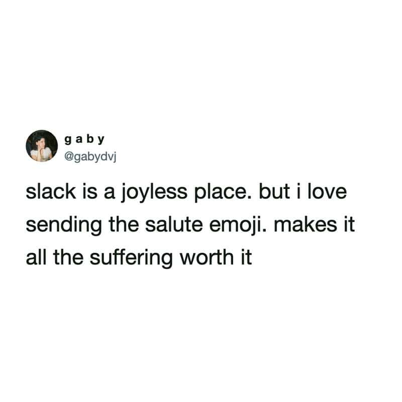 slack meme by @gabydvj describing the digital workspace as a "joyless place" where the only small spark of happiness comes from the daily ritual of sending the salute emoji.