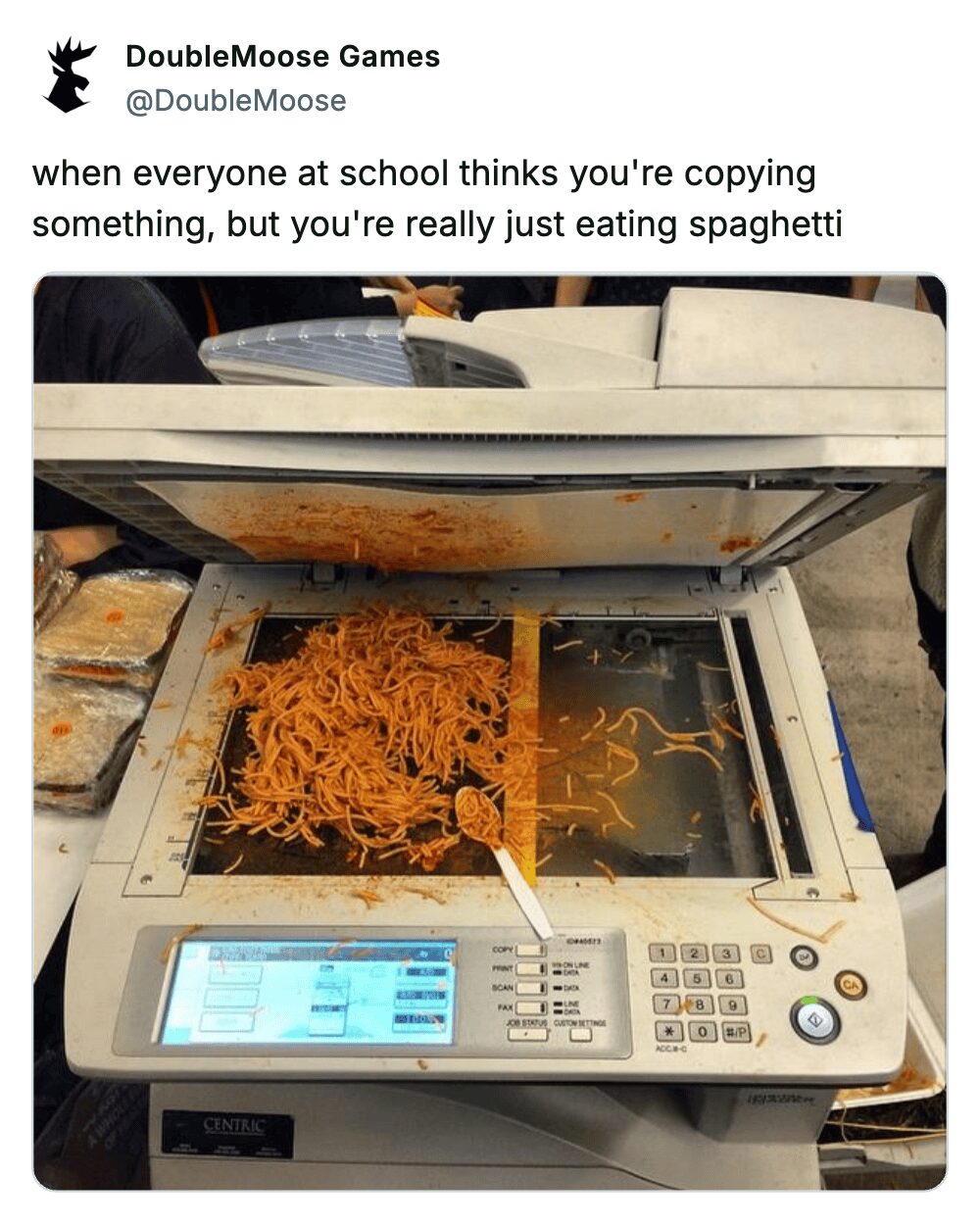 A funny photo of a copy machine covered in spaghetti with a relatable school-themed caption.