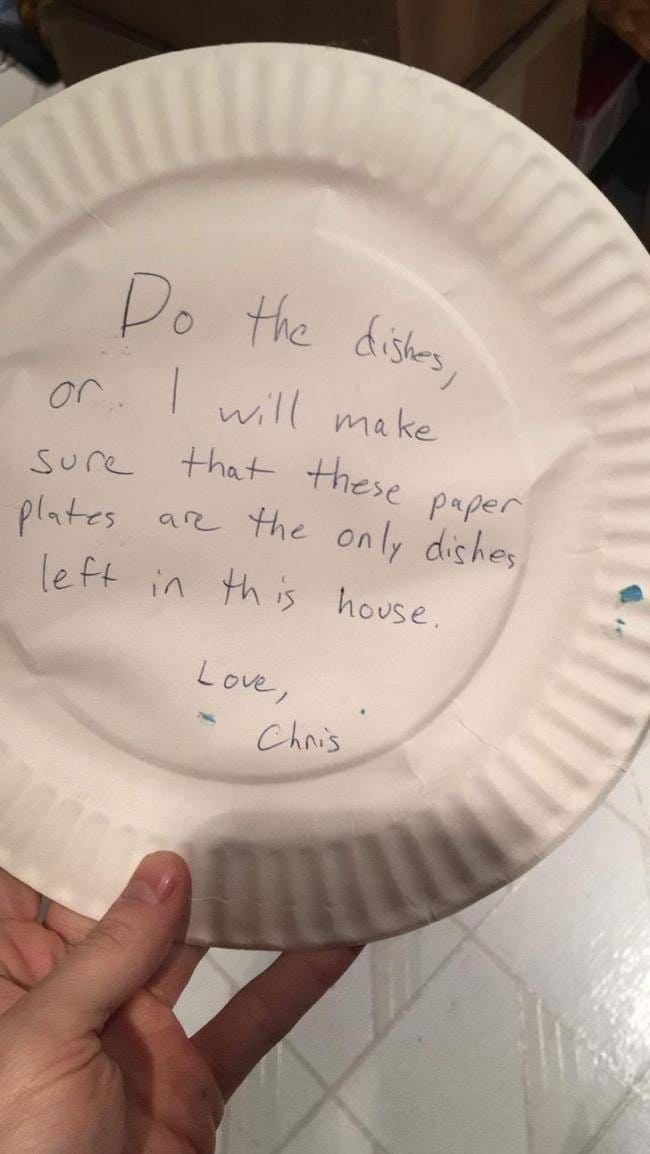 passive-aggressive response to the worst roommates. A hand holds a white paper plate featuring a sharp handwritten threat: "Do the dishes, or I will make sure that these paper plates are the only dishes left in this house. Love, Chris."