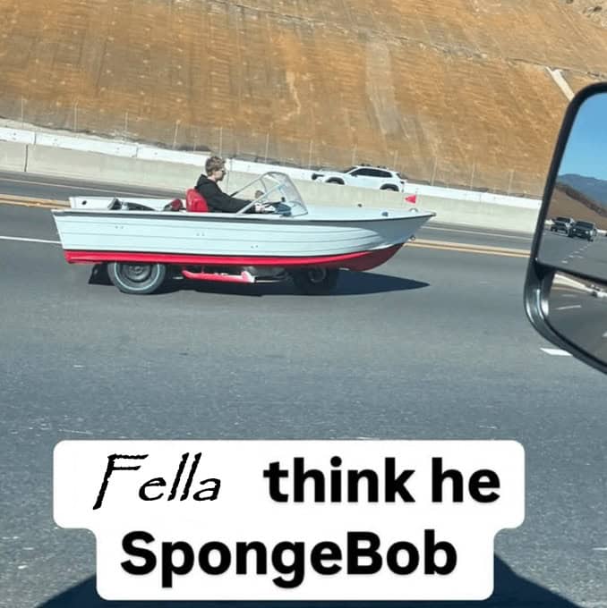 custom vehicle spotted on the highway where the body of a small motorboat has been perfectly integrated onto a car chassis, creating a functional "land boat" that looks like a life-sized Spongebob Squarepants prop.