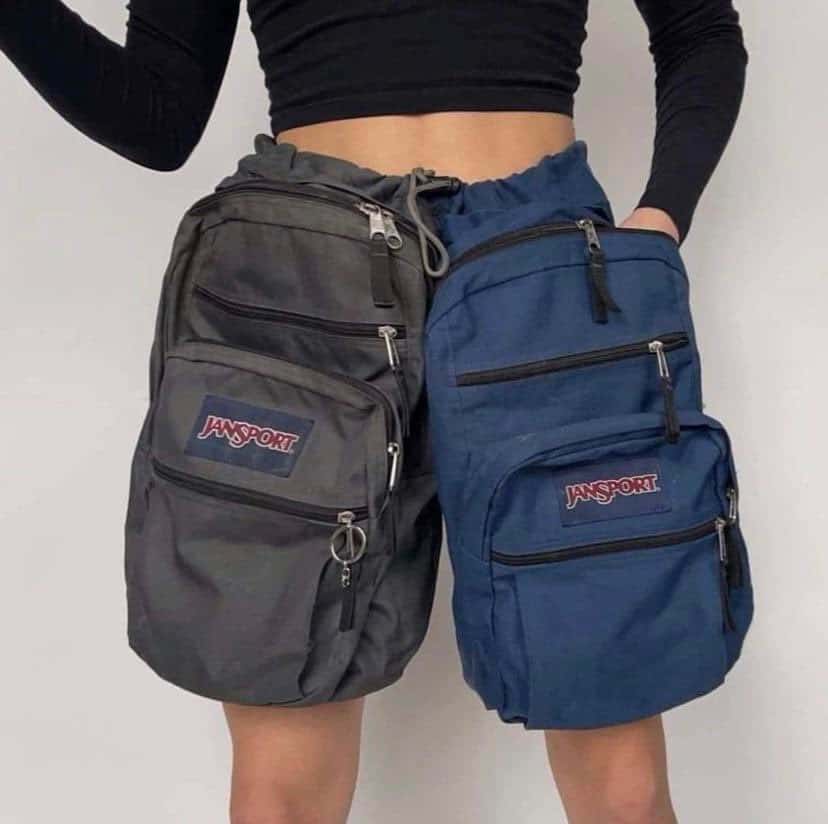 An experimental high-fashion look consisting of a deconstructed mini-skirt or shorts created by sewing together a grey and a blue JanSport backpack.