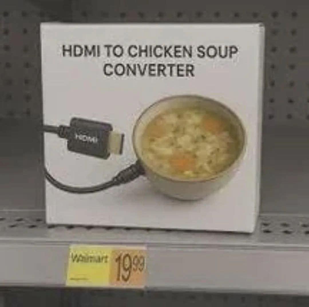 nonsensical classic meme showing a "HDMI TO CHICKEN SOUP CONVERTER" product box on a Walmart shelf for $19.99. The packaging features a 3D graphic of an HDMI cable plugging directly into the side of a ceramic bowl of noodle soup.