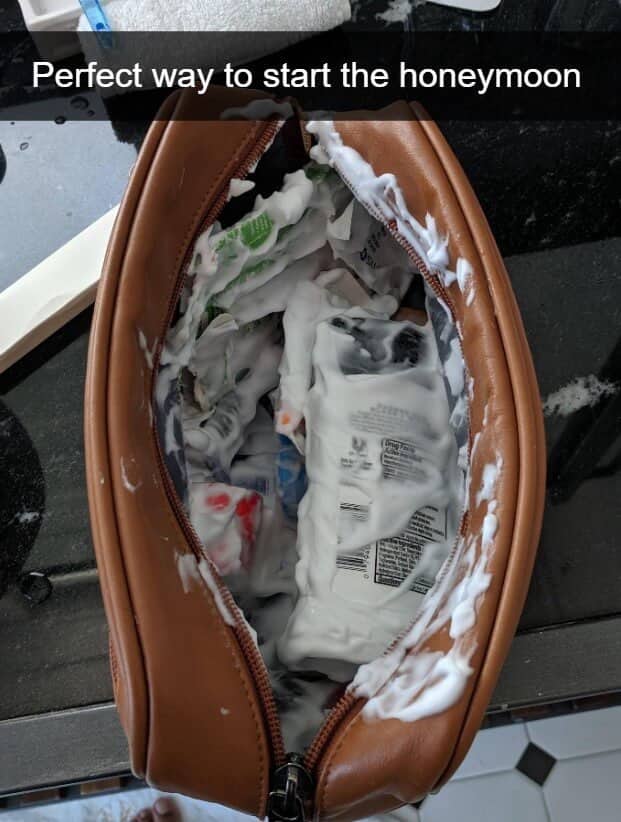 A brown toiletry bag filled with exploded shaving cream with a sarcastic honeymoon caption.