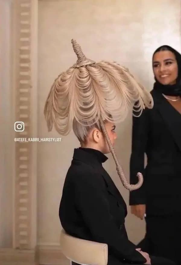 High-fashion hairstyle meticulously shaped into a functional umbrella made entirely of blonde hair.