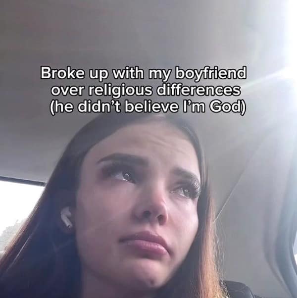 A "main character energy" hilarious meme featuring a girl looking tearful in a car with the text: "Broke up with my boyfriend over religious differences (he didn’t believe I’m God)."
