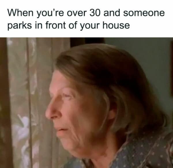 relatable millennial meme about the transition into aging. The text, "When you’re over 30 and someone parks in front of your house," is paired with a blurry image of a woman peering intensely through her window blinds with a suspicious expression.