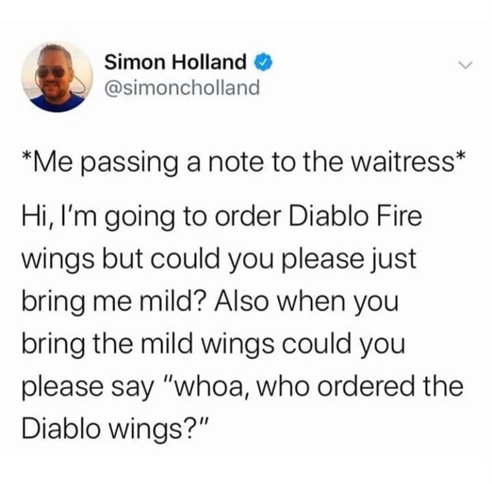 An oddly specific tweet by Simon Holland (@simoncholland) detailing a plan to look tough at a restaurant by passing the waitress a secret note asking her to bring mild wings but loudly yell, "whoa, who ordered the Diablo wings?"