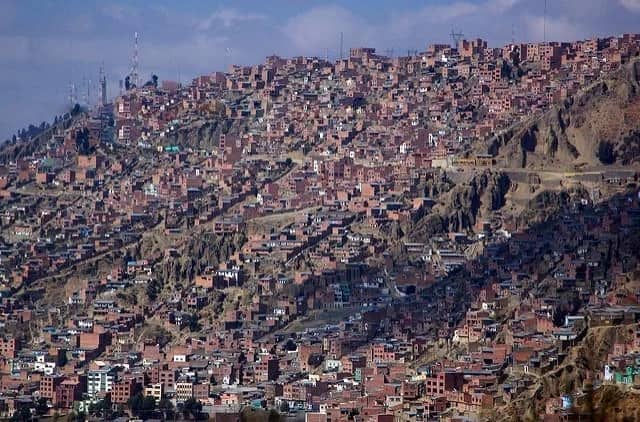 Densely packed brick hillside informal settlement covering entire mountainside in La Paz Bolivia