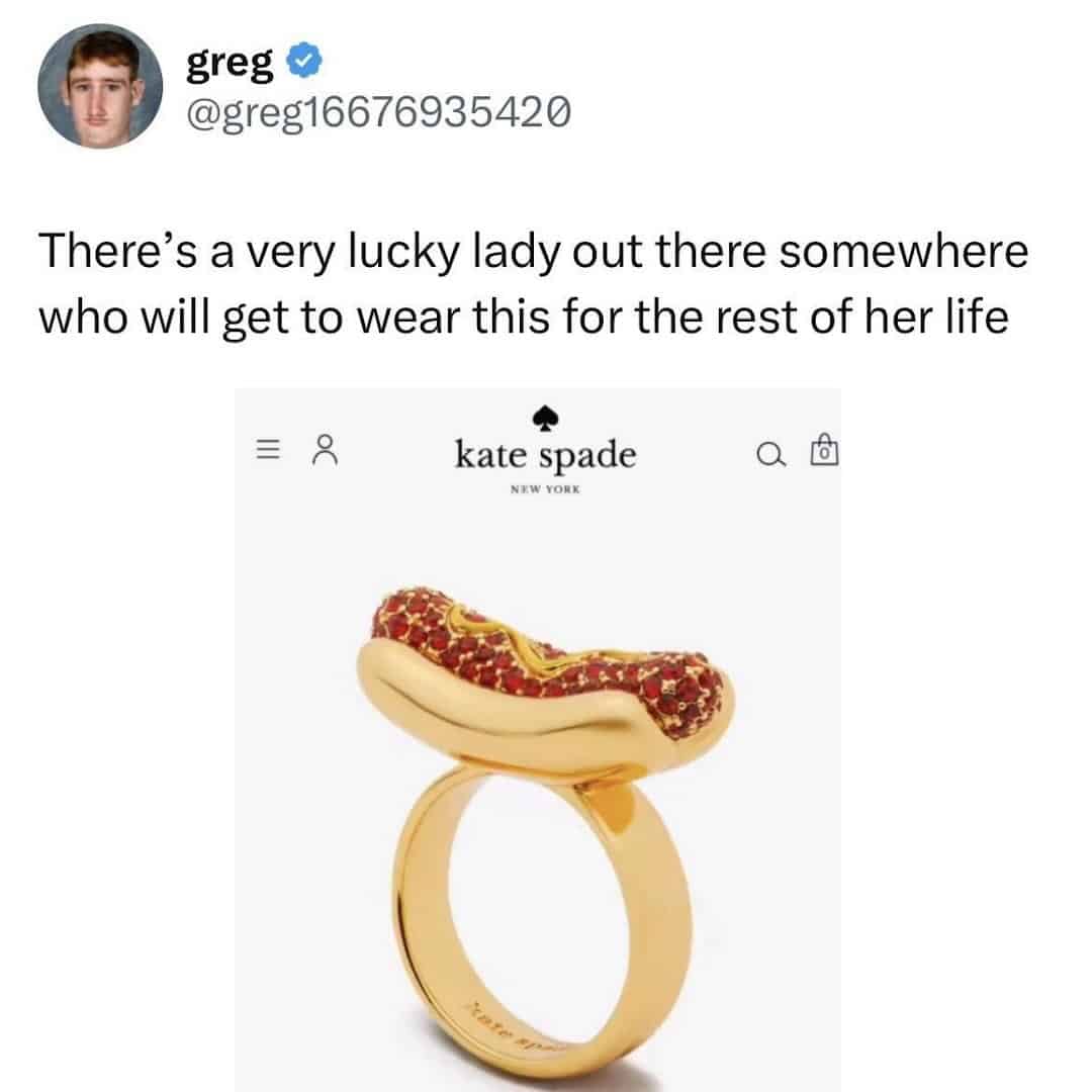 A tweet featuring a weird fashion engagement ring alternative from Kate Spade. The gold band is topped with a realistic miniature hot dog encrusted with red and yellow jewels to represent ketchup and mustard.