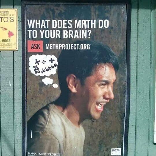 An anti-drug poster asking "WHAT DOES METH DO TO YOUR BRAIN?" featuring a man’s face. A clever bit of wholesome vandalism has added a hand-drawn thought bubble filled with arithmetic symbols like $+$ and $\div$, punning on the word "Meth" by making it look like he is just struggling with "Math."
