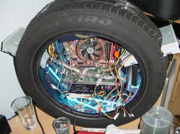 Full PC motherboard and components built inside a car tire used as a case