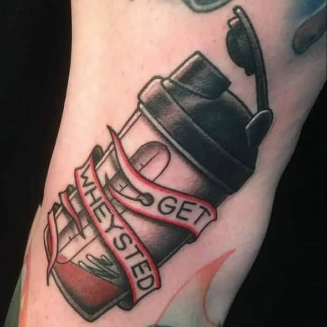 Protein shaker bottle tattoo wrapped in a banner reading get wheysted highlighting funny tattoos