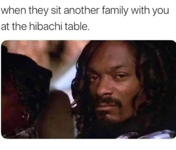 Snoop Dogg giving a side-eye, captioned as being seated with another family at hibachi.
