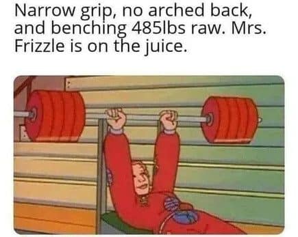 Ms. Frizzle bench pressing a massive barbell, joked about as lifting 485 pounds raw.