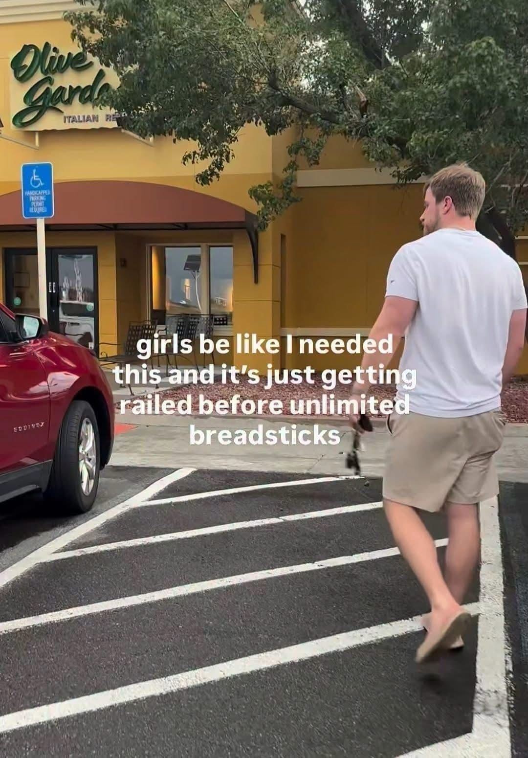 Man walking toward an Olive Garden with a crude caption about unlimited breadsticks.