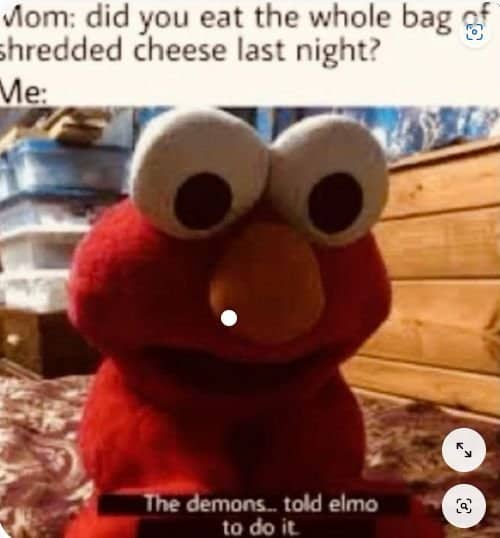 Close up Elmo doll with subtitle saying the demons told Elmo to eat the shredded cheese