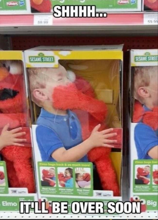Store shelf of Elmo hug toys with boxes showing a boy squeezed in a big Elmo hug