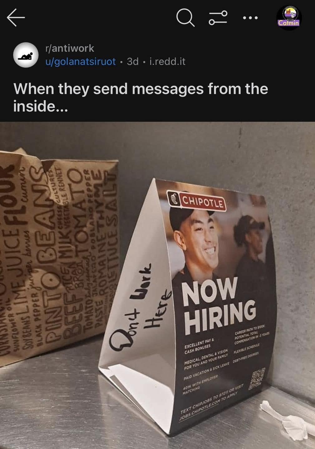 Chipotle now hiring sign where someone scribbled don't work here on the bag.