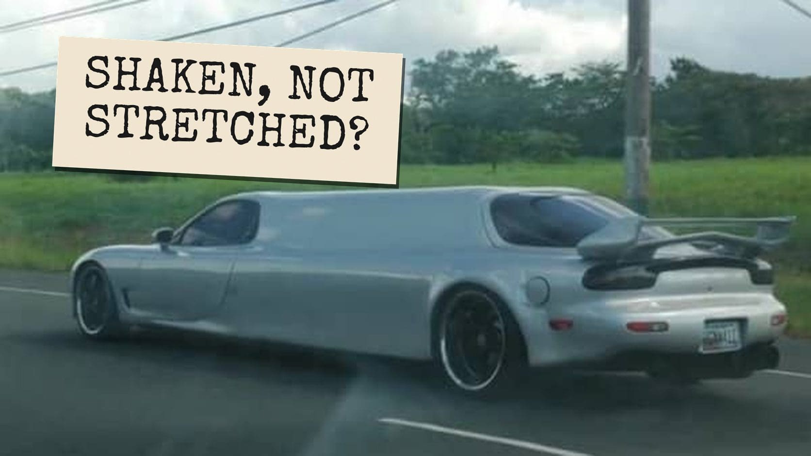 Silver sports car stretched into a long limousine on a country road, a perfect not so classy memes moment.