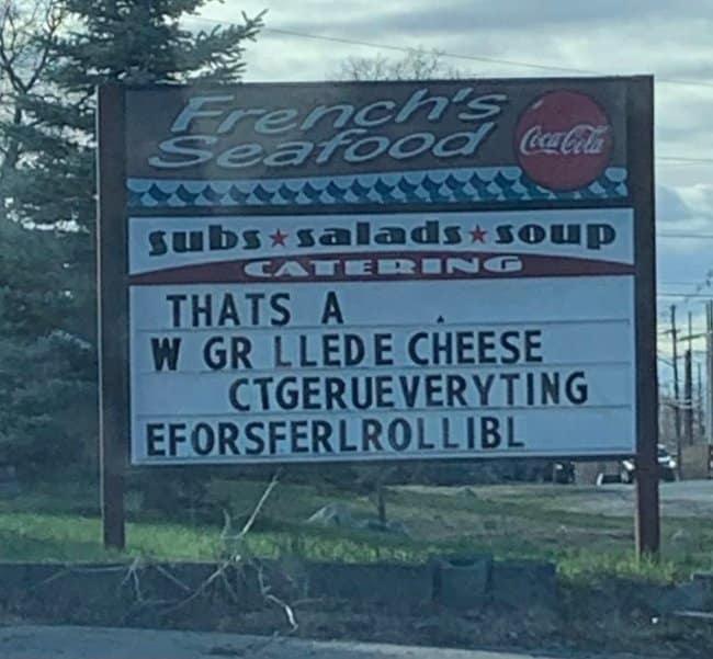 French's Seafood marquee with scrambled letters, spelling fails promoting a grilled cheese.