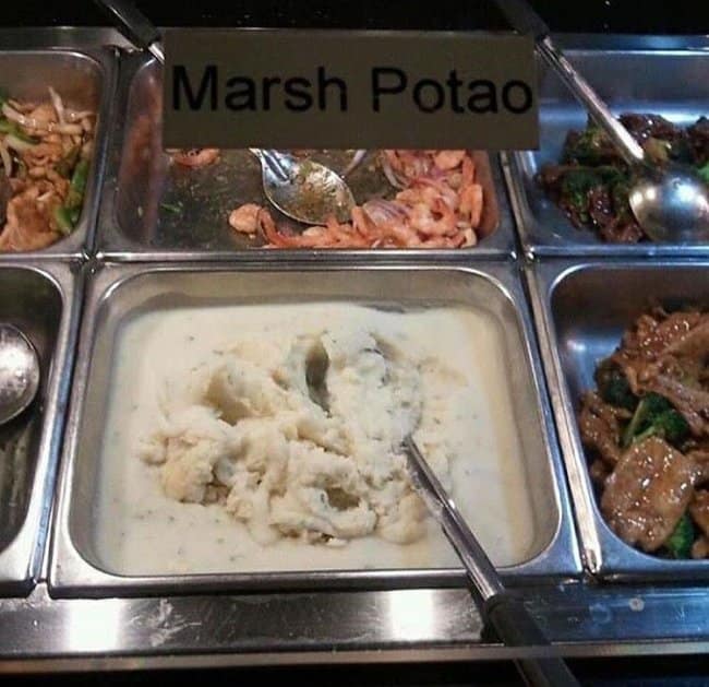 Buffet tray of mashed potatoes under a sign reading Marsh Potao.