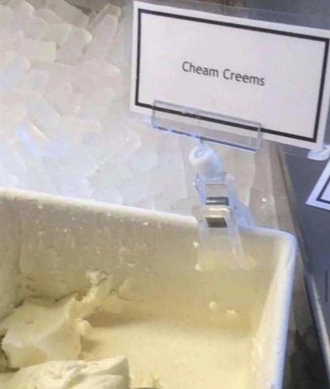 Ice cream tub labeled Cheam Creems in a freezer case, sweet spelling fails.
